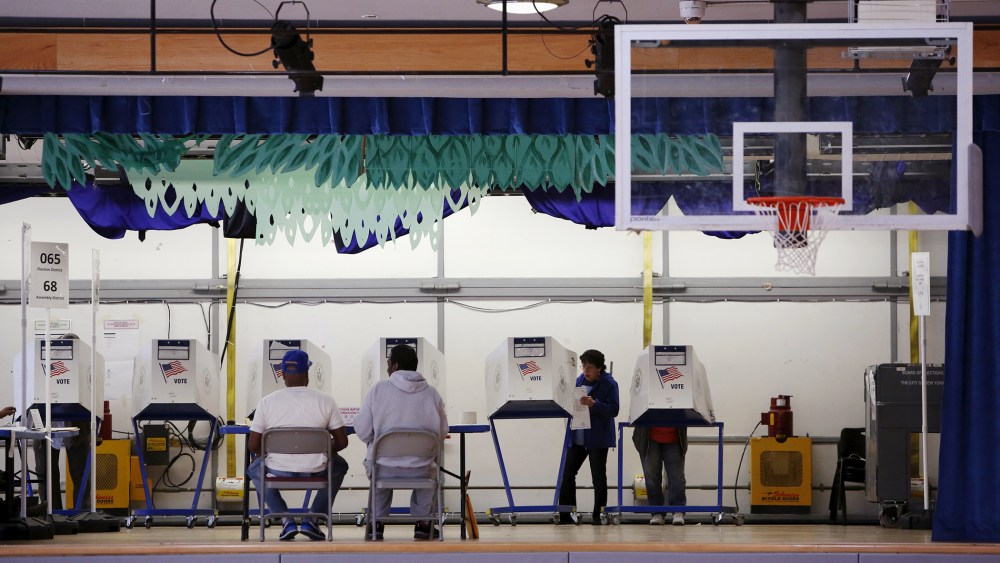 Voters use booths located on the stage at the polling center at the James Weldon Johnson Community Center during the New York primary elections in East Harlem, New York City, April 19, 2016. (Photo by Andrew Kelly/Reuters)