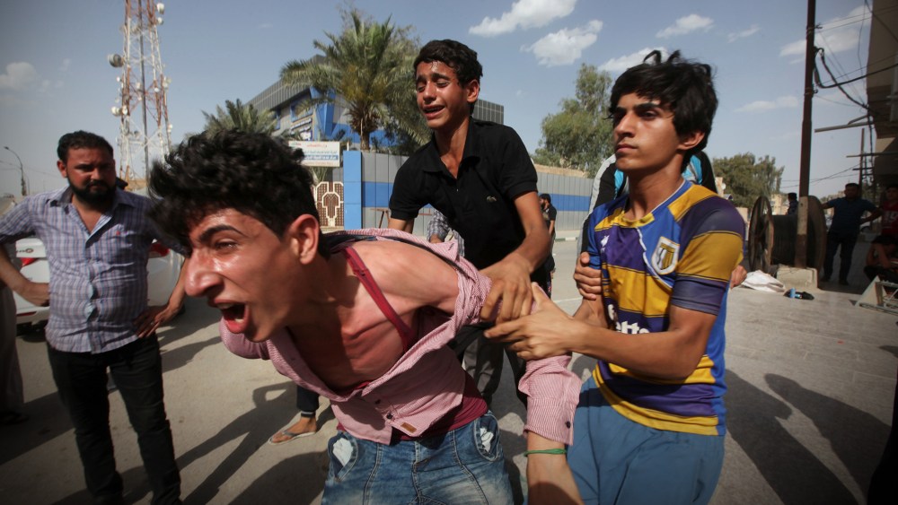 Mourners react during a funeral of a victim who was killed in a bomb attack in Samawa, south of Baghdad, Iraq May 1, 2016. (Photo by Alaa Al-Marjani/Reuters)