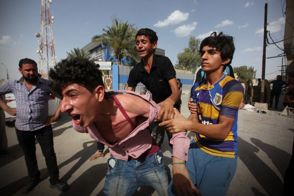 Mourners react during a funeral of a victim who was killed in a bomb attack in Samawa, south of Baghdad, Iraq May 1, 2016. (Photo by Alaa Al-Marjani/Reuters)