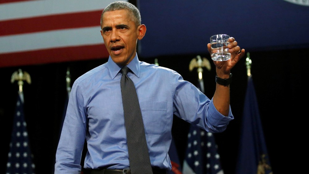 President Barack Obama drinks a glass of filtered water from Flint, a city struggling with the effects of lead-poisoned drinking water, as he delivers remarks at North Western High School in Mich., May 4, 2016. (Photo by Carlos Barria/Reuters)
