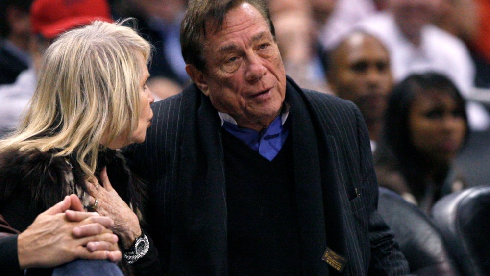 Los Angeles Clippers owner Donald Sterling sits with an unidentified companion as he watches the team play New York Knicks.