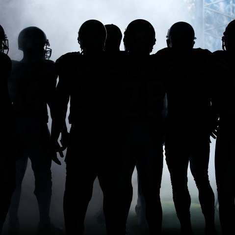 NFL players wait to be introduced to the crowd before playing in a game. (Photo by Mike Blake/Reuters)