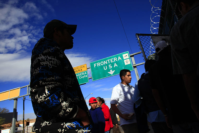 People wait outside an aid center near a truck port of entry in Nogales, Mexico, November 11, 2010.  (Photo by Eric Thayer/Reuters)