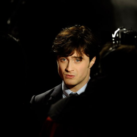 Britain's Daniel Radcliffe is seen posing as he arrives for the world premiere of "Harry Potter and the Deathly Hallows: Part 1" at Leicester Square in London, Nov. 11, 2010. (Photo by Dylan Martinez/Reuters)