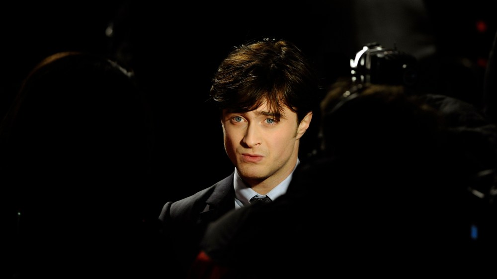 Britain's Daniel Radcliffe is seen posing as he arrives for the world premiere of "Harry Potter and the Deathly Hallows: Part 1" at Leicester Square in London, Nov. 11, 2010. (Photo by Dylan Martinez/Reuters)