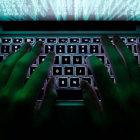 A man types on a computer keyboard. (Photo by Kacper Pempel/Reuters)
