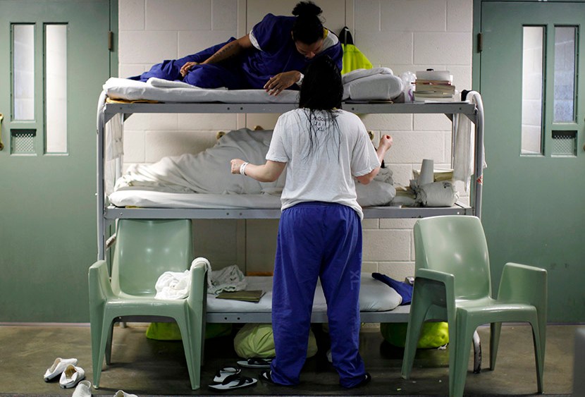 Women chat as they lie in beds placed in the communal area outside cells, due to overcrowding at the Los Angeles County Women's jail in Lynwood, California April 26, 2013. (Photo by Lucy Nicholson/Reuters)