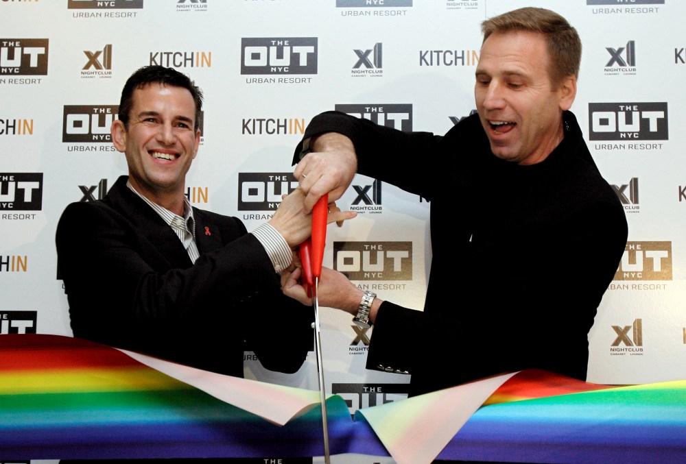 Ian Reisner, left, and Mati Weiderpass, co-owners of The Out NYC hotel, cut the ribbon for New York's new gay resort hotel, March 1, 2012. (Photo by Richard Drew/AP)