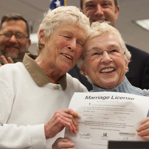 Jane Abbott Lighty, left, and Pete-e Petersen embrace after receiving the first same-sex marriage license in Washington state at the King County Recorder’s Office. (Photo by David Ryder/Getty Images)