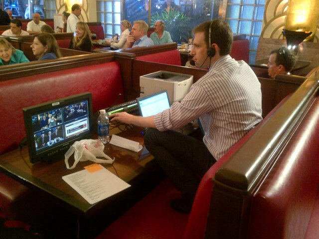 Executive Producer Alex Korson perches on a booth