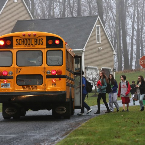 Children return to school on December 18, 2012 in Newtown, Connecticut, four days after the Sandy Hook Elementary massacre. (John Moore/Getty Images)