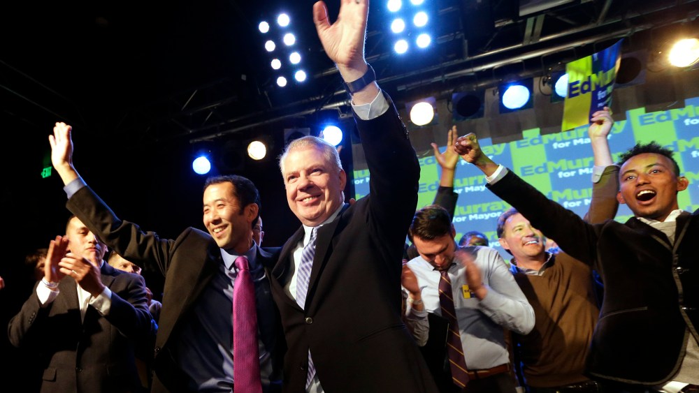 Seattle mayoral candidate state Sen. Ed Murray waves with his husband at an election night party Tuesday, Nov. 5, 2013, in Seattle.