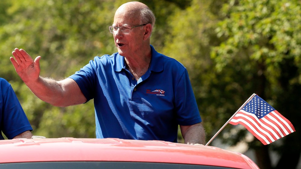 U.S. Sen. Pat Roberts waves to the crowd as he rides on the back of a pickup in a parade Saturday, Aug. 2, 2014, in Gardner, Kan.