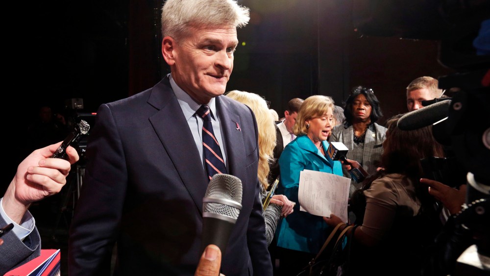 Senate candidate, Rep. Bill Cassidy, left, talks to the media in Shreveport, La. on Oct. 14, 2014.