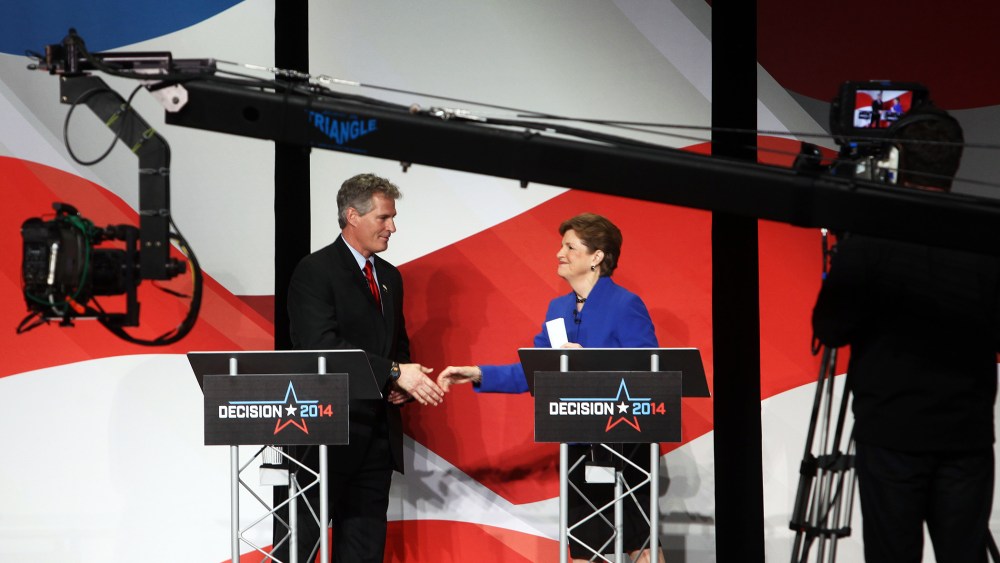 U.S. Sen. Jeanne Shaheen, right, shakes hands with Republican challenger Scott Brown on Oct. 21, 2014 in Concord, N.H.