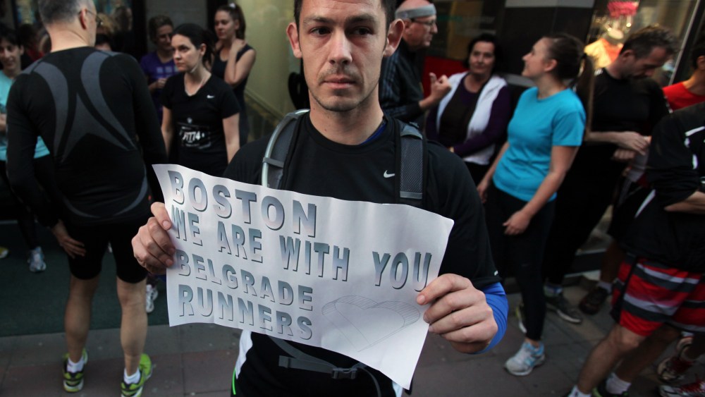 A runner shows a banner reading: "Boston we are with you - Belgrade runners" in an organized memorial run to show solidarity with victims of the Boston Marathon bombing, Tuesday, April 16, 2013, in Belgrade, Serbia. (Photo by Darko Vojinovic/AP Photo)