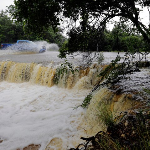 A motorist passes through a low-water crossing near New Braunfels, Texas, June 2, 2016. (Photo by Eric Gay/AP)