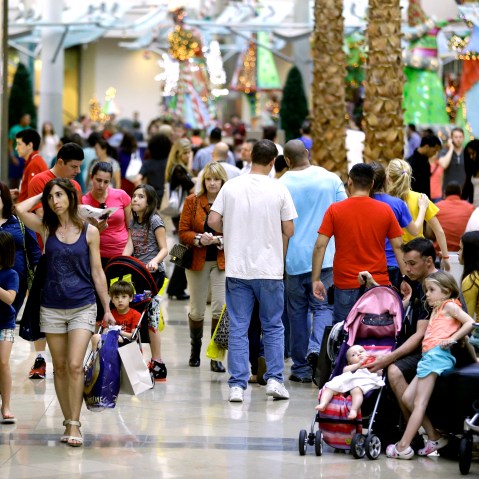 In this Thursday, Dec. 20, 2012 photo, holiday shoppers make their way through The Mall at Millenia in Orlando, Fla. U.S. holiday retail sales this year are the weakest since 2008, after a shopping season disrupted by storms and rising uncertainty...