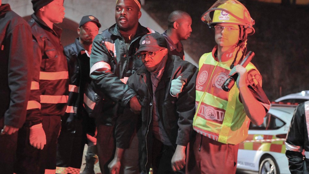 An injured passenger is helped to an ambulance at the Booysens train station near Johannesburg, South Africa on July 17, 2015. (Photo by AP)