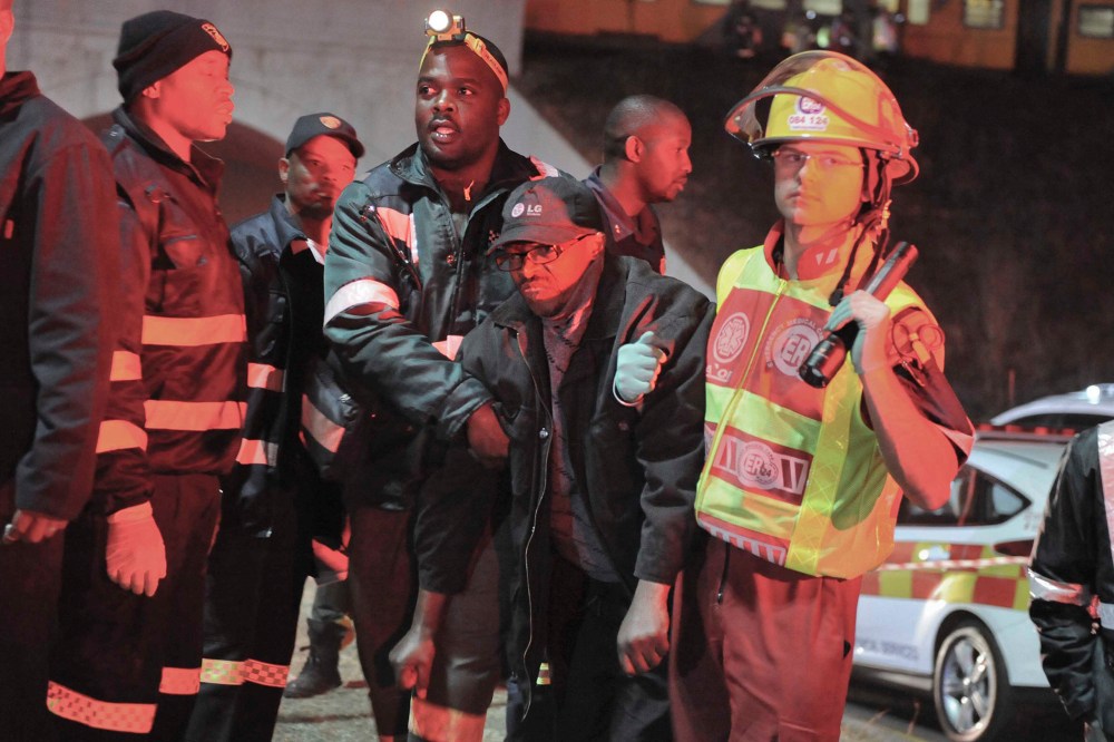 An injured passenger is helped to an ambulance at the Booysens train station near Johannesburg, South Africa on July 17, 2015. (Photo by AP)