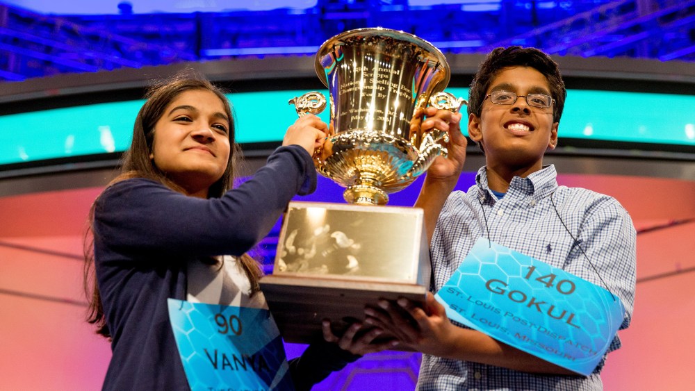 Vanya Shivashankar, left, 13, of Olathe, Kan., and Gokul Venkatachalam, 14, of St. Louis, hold up the championship trophy as co-champions after winning the finals of the Scripps National Spelling Bee, May 28, 2015, in Oxon Hill, Md. (Andrew Harnik/AP)