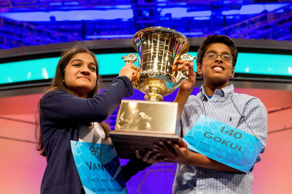 Vanya Shivashankar, left, 13, of Olathe, Kan., and Gokul Venkatachalam, 14, of St. Louis, hold up the championship trophy as co-champions after winning the finals of the Scripps National Spelling Bee, May 28, 2015, in Oxon Hill, Md. (Andrew Harnik/AP)