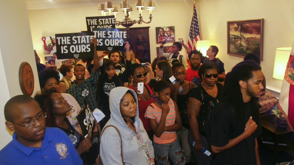 Protesters crowd into Florida Gov. Rick Scott's office Tuesday July 16, 2013, at the Capitol in Tallahassee, Fla. Dream Defenders organized a sit-in of Florida Gov. Rick Scott's office in response to the not guilty verdict in the trial of George...