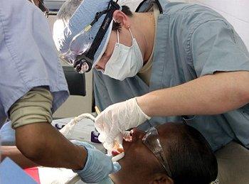 Military personnel performing dentistry in rural Alabama.
