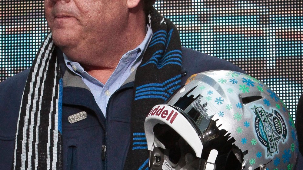 New Jersey Gov. Chris Christie holds a souvenir football helmet as he leaves after a ceremony to pass official hosting duties of next year's Super Bowl to representatives from Arizona, Saturday Feb. 1, 2014 in New York.