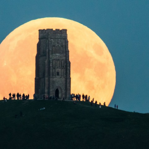 The supermoon rises behind Glastonbury Tor on Sept. 27, 2015 in Glastonbury, England.