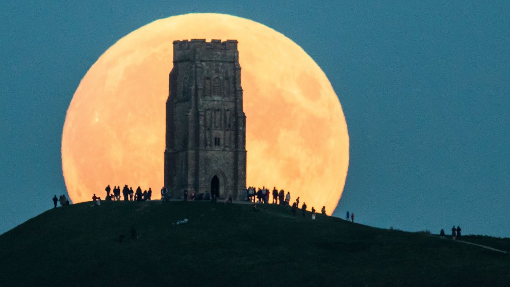 The supermoon rises behind Glastonbury Tor on Sept. 27, 2015 in Glastonbury, England.