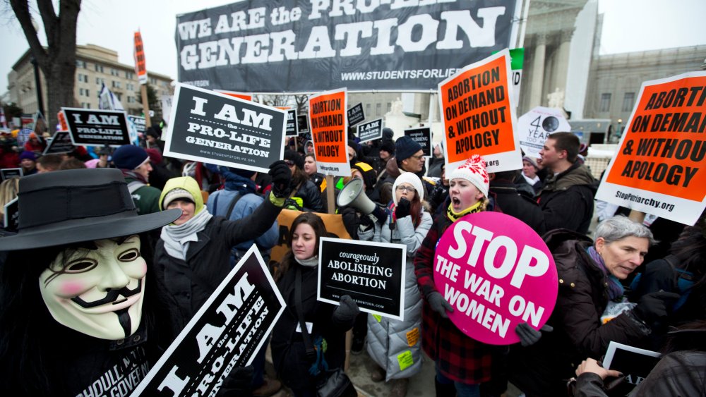 Pro-abortion rights activists, rally face-to-face against anti-abortion demonstrators as both march in front of the U.S. Supreme Court in Washington, D.C., January 25, 2013.