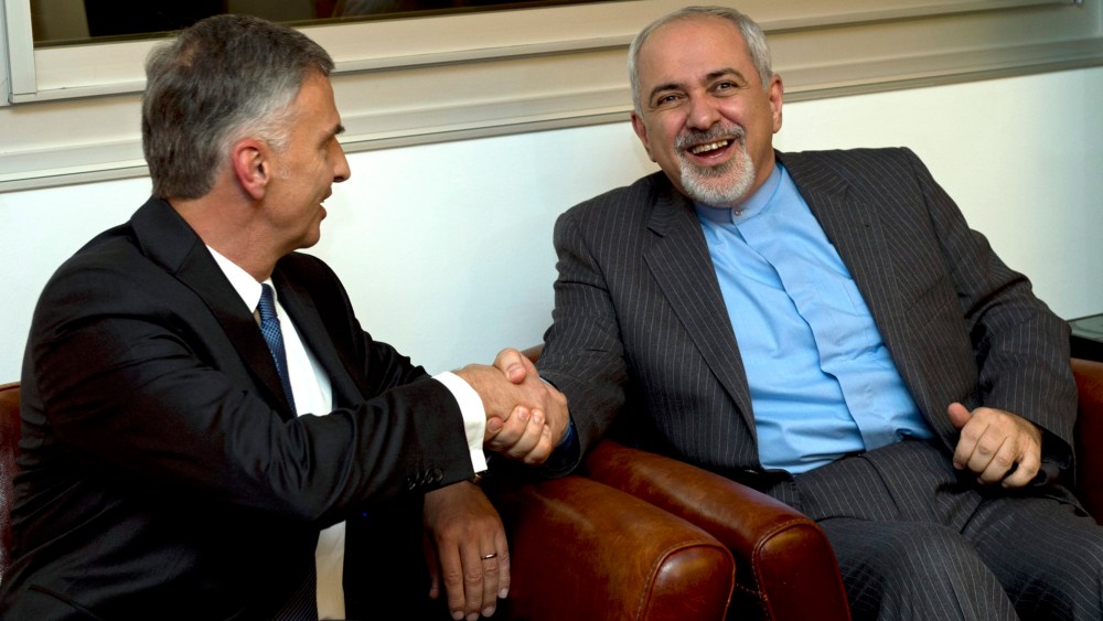 Switzerland's Foreign Minister Didier Burkhalter, left, shakes hands with Iranian Foreign Minister Mohammad-Javad Zarif, during a meeting at the Intercontinental Hotel prior to talks about Iran's nuclear programme in Geneva, Switzerland, Saturday, Nov. 23
