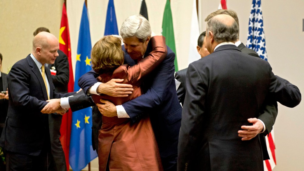 U.S. Secretary of State John Kerry, center, embraces EU foreign policy chief Catherine Ashton, during a ceremony at the United Nations after an agreement was reached on Iran's nuclear program,  in Geneva, Switzerland, Sunday, Nov. 24, 2013.