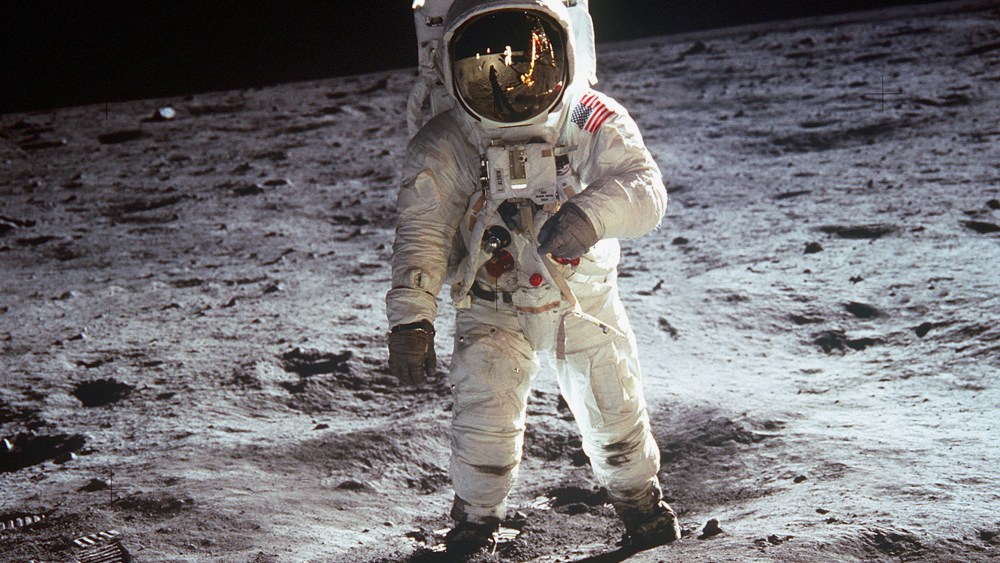 American astronaut Edwin "Buzz" Aldrin walking on the moon on July 20, 1969 during Apollo 11 mission. Neil Armstrong's reflection in the visor of the helmet. (Photo by Apic/Getty Images)