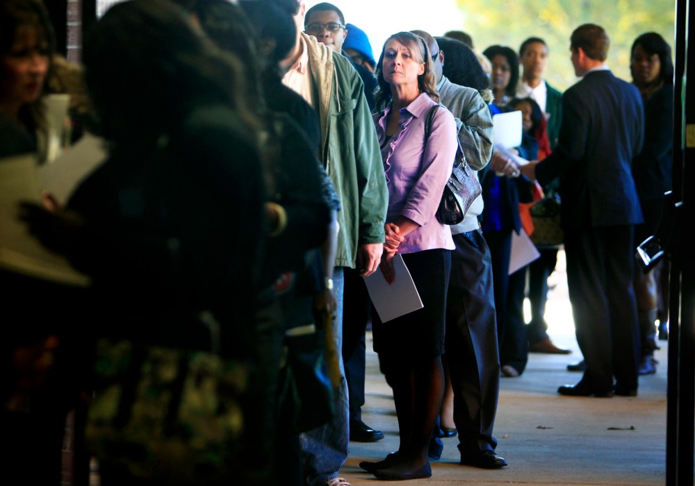 Jona Caldwell joins a long line of job seekers outside the Ferguson Community Center in Cordova, Tenn. waiting to get into a Tennessee Department of Labor job fair Thursday, Nov. 7, 2013.