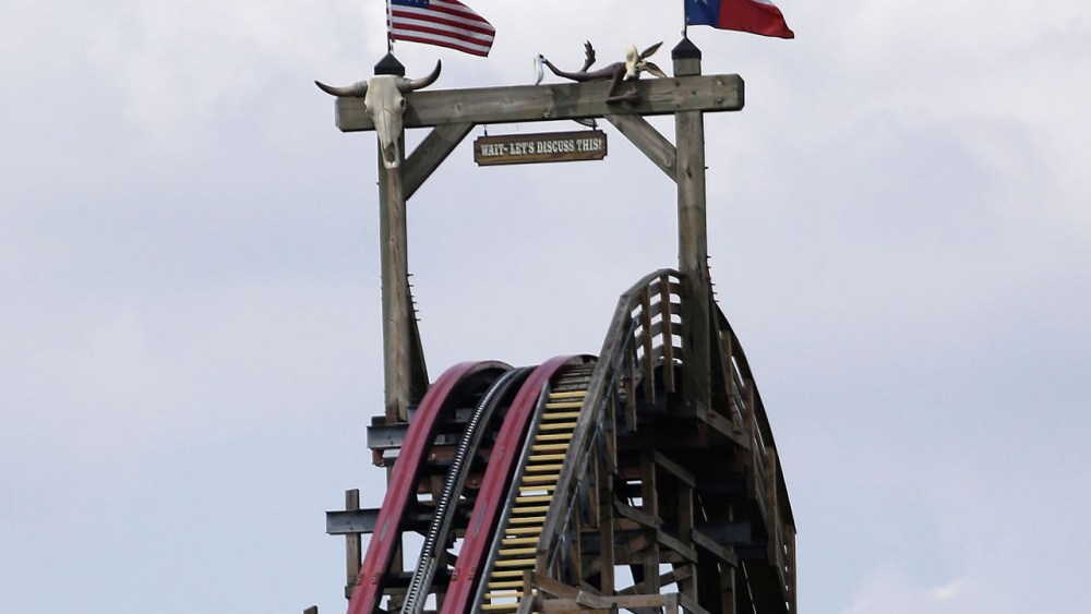 The Texas Giant roller coaster ride sits idle at the Six Flags Over Texas park Saturday, July 20, 2013, in Arlington, Texas. Investigators will try to determine if a woman who died while riding the roller coaster at the amusement park Friday night fell...