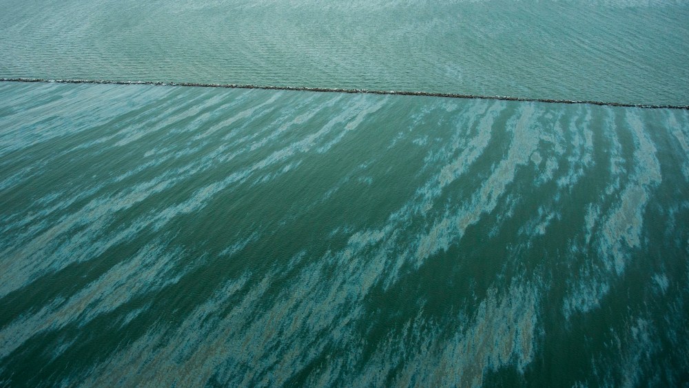 A sheen is seen on the water near East Beach and the Galveston Jetties on March 23, 2014, in Galveston, Texas.