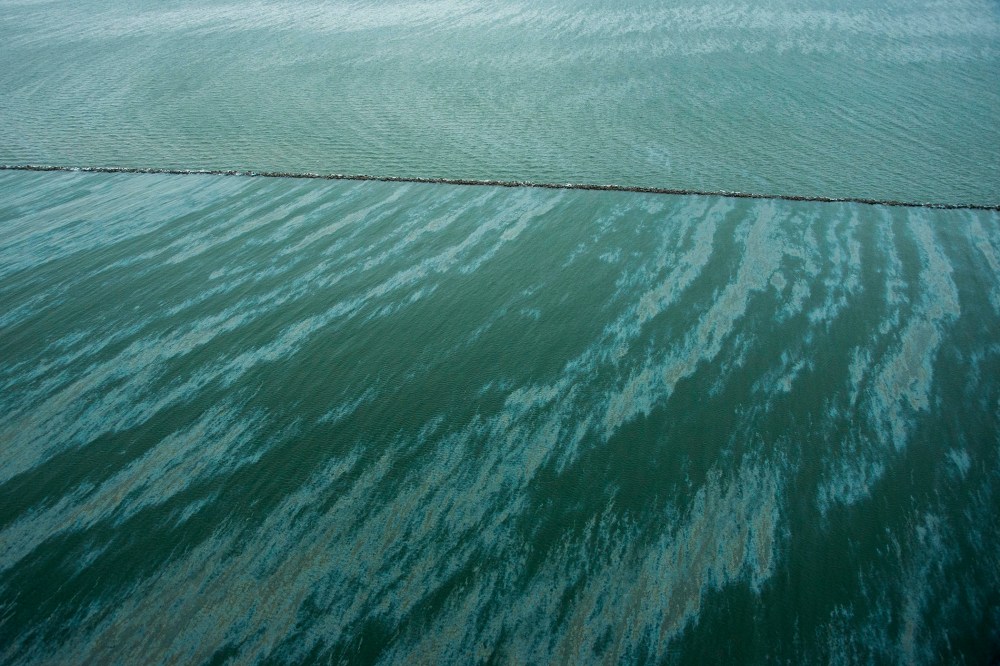 A sheen is seen on the water near East Beach and the Galveston Jetties on March 23, 2014, in Galveston, Texas.