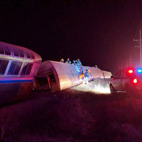 Emergency personnel work on a train that derailed near Dodge City, Kan., March 14, 2016. (Photo by Daniel Szczerba/AP)