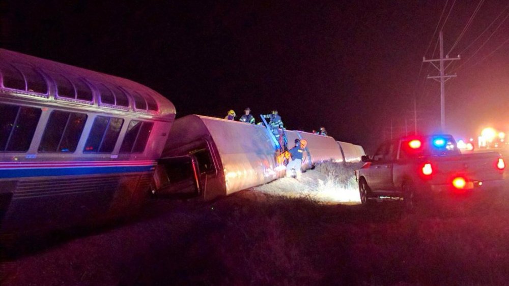 Emergency personnel work on a train that derailed near Dodge City, Kan., March 14, 2016. (Photo by Daniel Szczerba/AP)