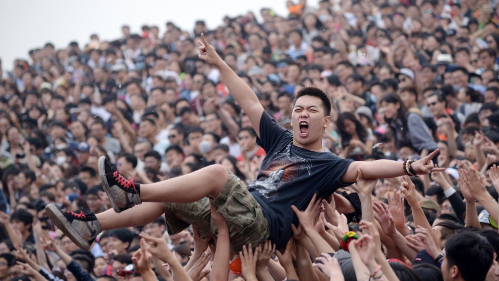 A crowd surfer gestures during the Strawberry Music Festival in Beijing on May 1, 2014.