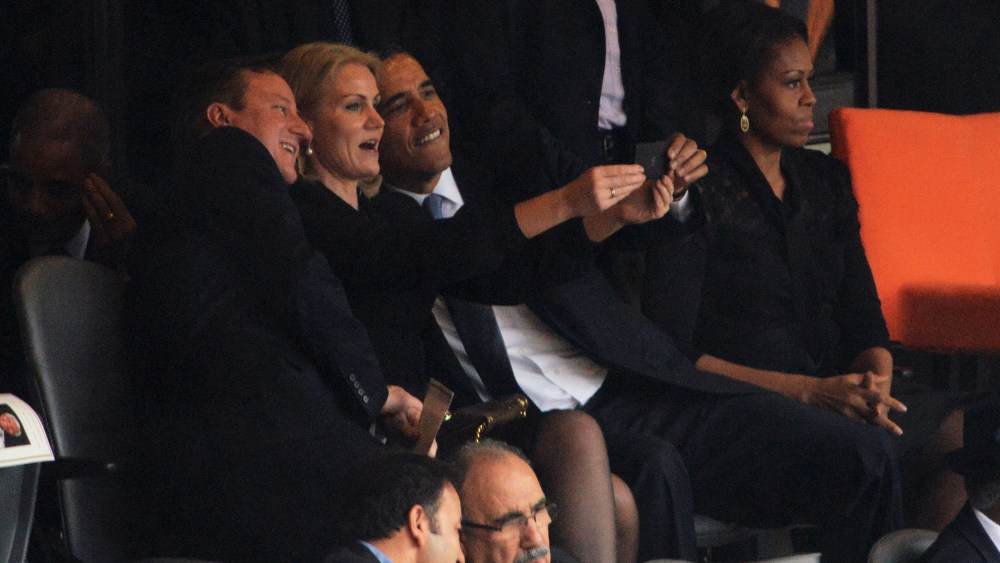 Barack Obama, British Prime Minister David Cameron and Denmark's Prime Minister Helle Thorning Schmidt pose for a picture during the memorial service for Nelson Mandela, Dec. 10, 2013.