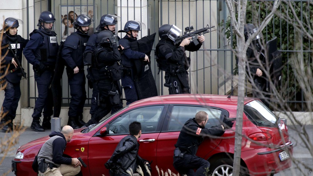 French Research and Intervention Brigades (BRI) policemen officers near a post office where an armed man is holed up with two hostages, on Jan. 16, 2015 in Colombes, outside Paris. (Photo by Kenzo Tribouillard/AFP/Getty)
