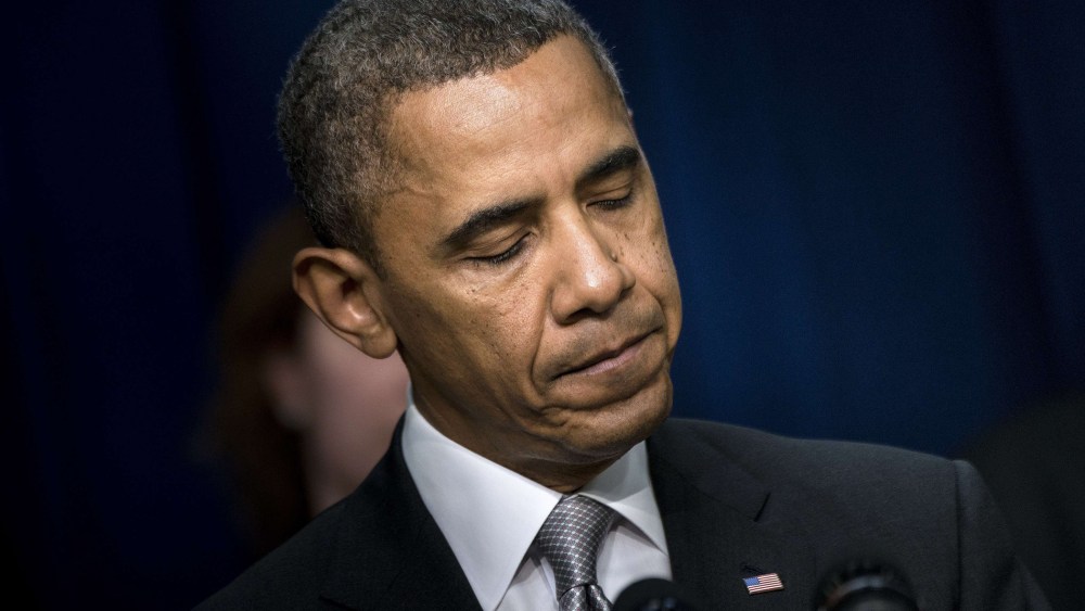 President Barack Obama pauses while speaking during an event on the grounds of the White House Dec. 3, 2013.