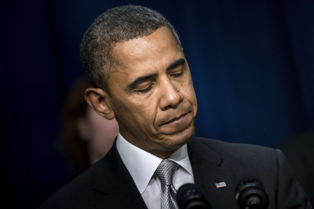 President Barack Obama pauses while speaking during an event on the grounds of the White House Dec. 3, 2013.