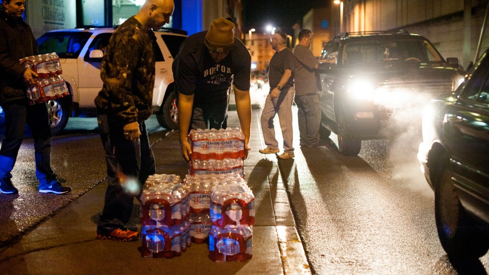 Lines of cars formed around the block as pallets of bottled water were being brought and distributed in downtown Charleston, West Virginia, Jan. 10, 2014.