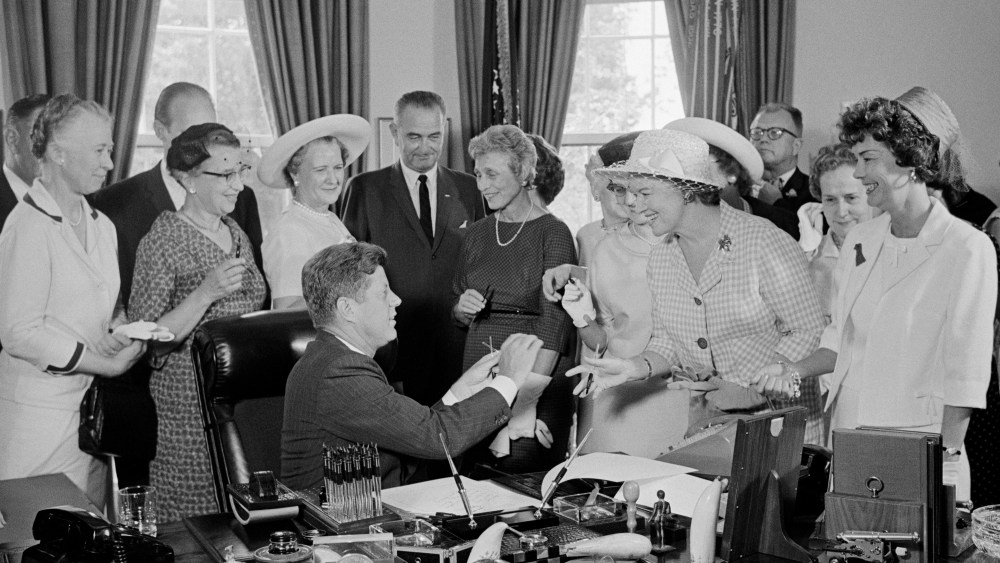President Kennedy is seen during a ceremony at the White House in which he signed into law a bill aimed at assuring women of paychecks equal to those of men doing the same work on June 10, 1963 in Washington, DC. (Photo by Bettmann/Corbis)