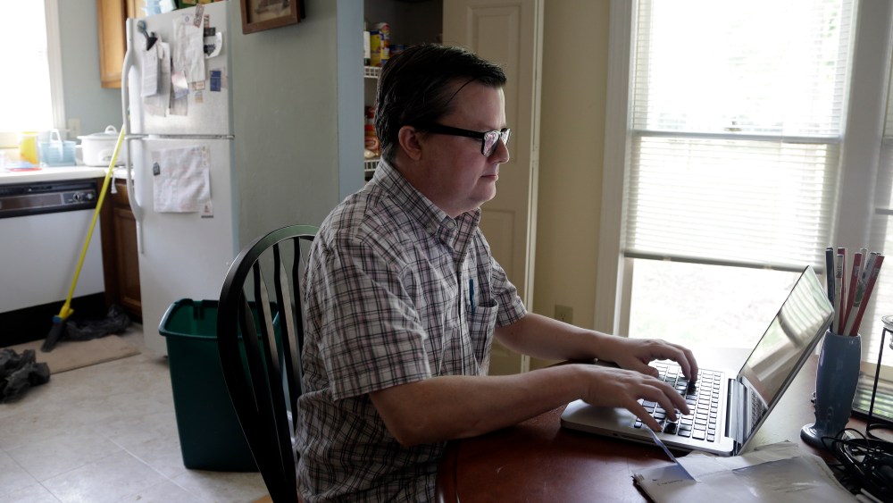 Lee Creighton looks for jobs on the Internet at his home in Cary, N.C., Thursday, June 27, 2013. Creighton has been unemployed since October and will receive his last bit of unemployment aid this week. (Photo by Gerry Broome/AP)