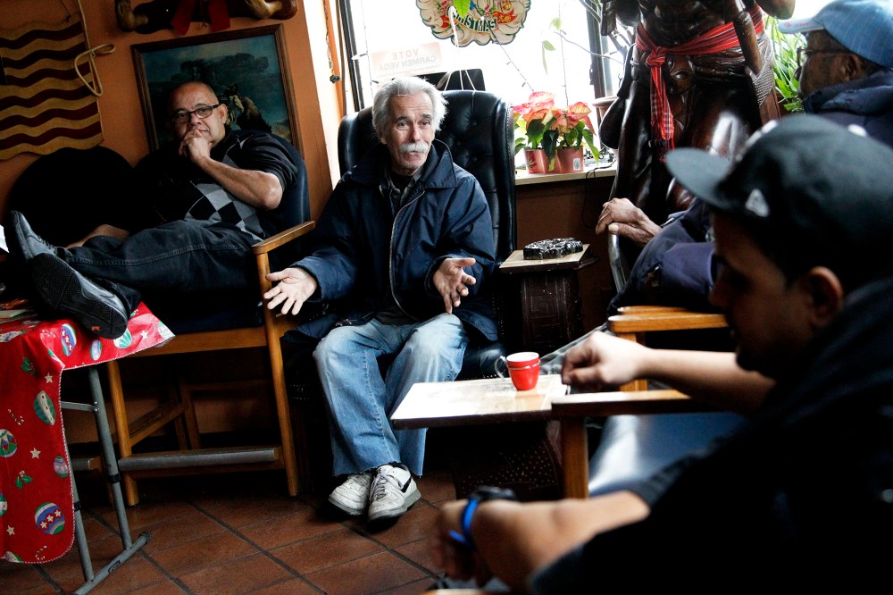 Roberto Martinez Gonzalez, 73, second from left, an former Cuban national who left his birth country during the El Mariel exodus, talks to Manuel Lopez, Juan Perez and Tony Montalvo regarding Cuba at a cigar shop on Dec. 17, 2014, in Union City, N.J.